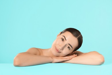 Photo of Portrait of beautiful woman after spa treatment on light blue background