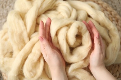 Photo of Woman with beige soft felting wool, top view