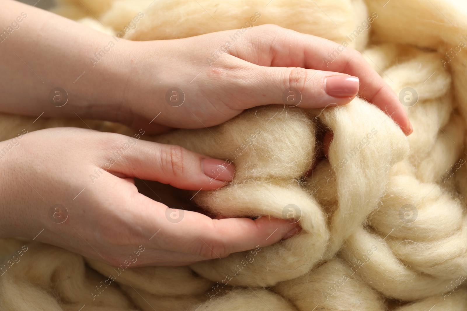 Woman with beige soft felting wool, top view Photo of Woman with beige soft felting wool, top view