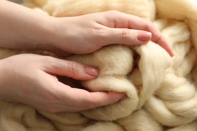 Photo of Woman with beige soft felting wool, top view
