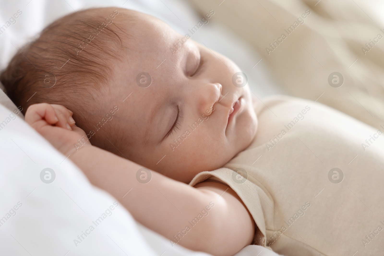 Cute newborn baby sleeping on bed indoors Photo of Cute newborn baby sleeping on bed indoors