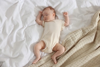 Photo of Cute newborn baby sleeping on bed indoors, top view