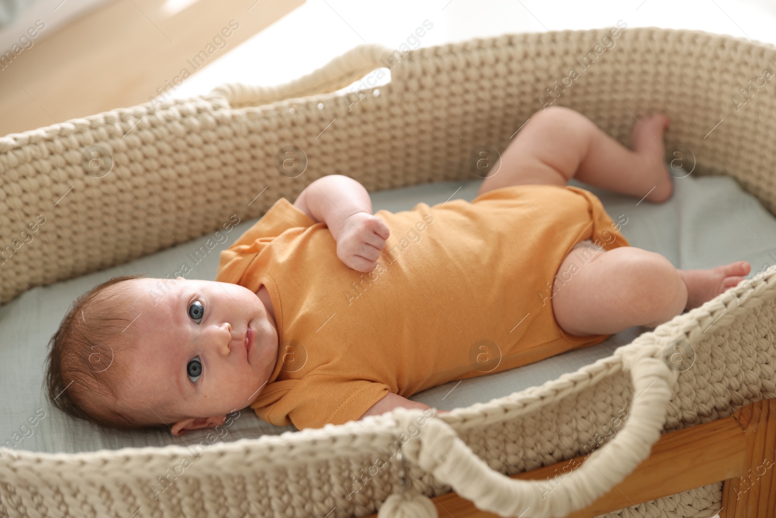 Cute newborn baby in bassinet at home Photo of Cute newborn baby in bassinet at home