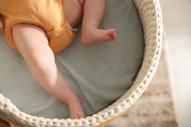 Photo of Cute newborn baby in bassinet, closeup view