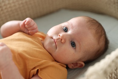 Photo of Cute newborn baby in bassinet, closeup view