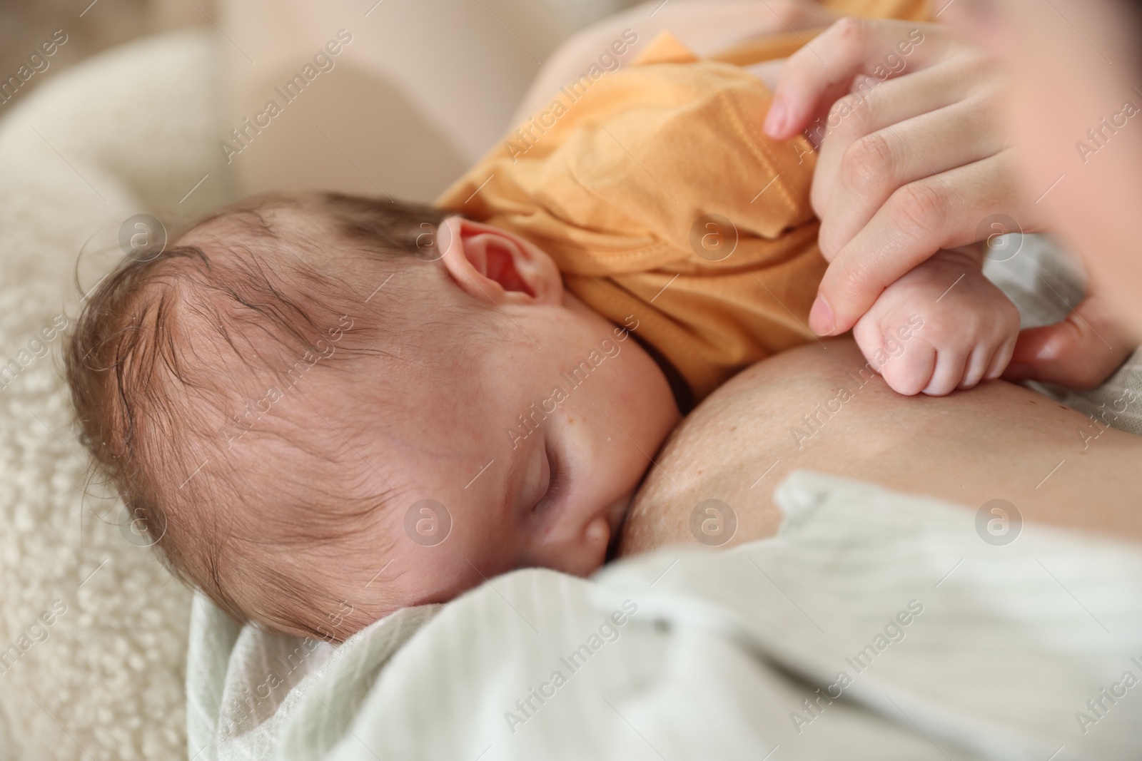 Mother breastfeeding her newborn baby at home, closeup Photo of Mother breastfeeding her newborn baby at home, closeup