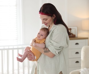 Photo of Mother with her cute newborn baby at home