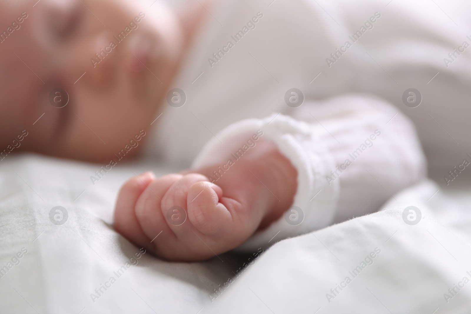 Cute newborn baby sleeping on bed, selective focus Photo of Cute newborn baby sleeping on bed, selective focus