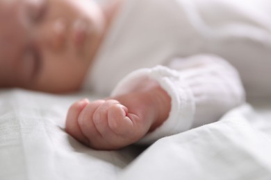 Photo of Cute newborn baby sleeping on bed, selective focus