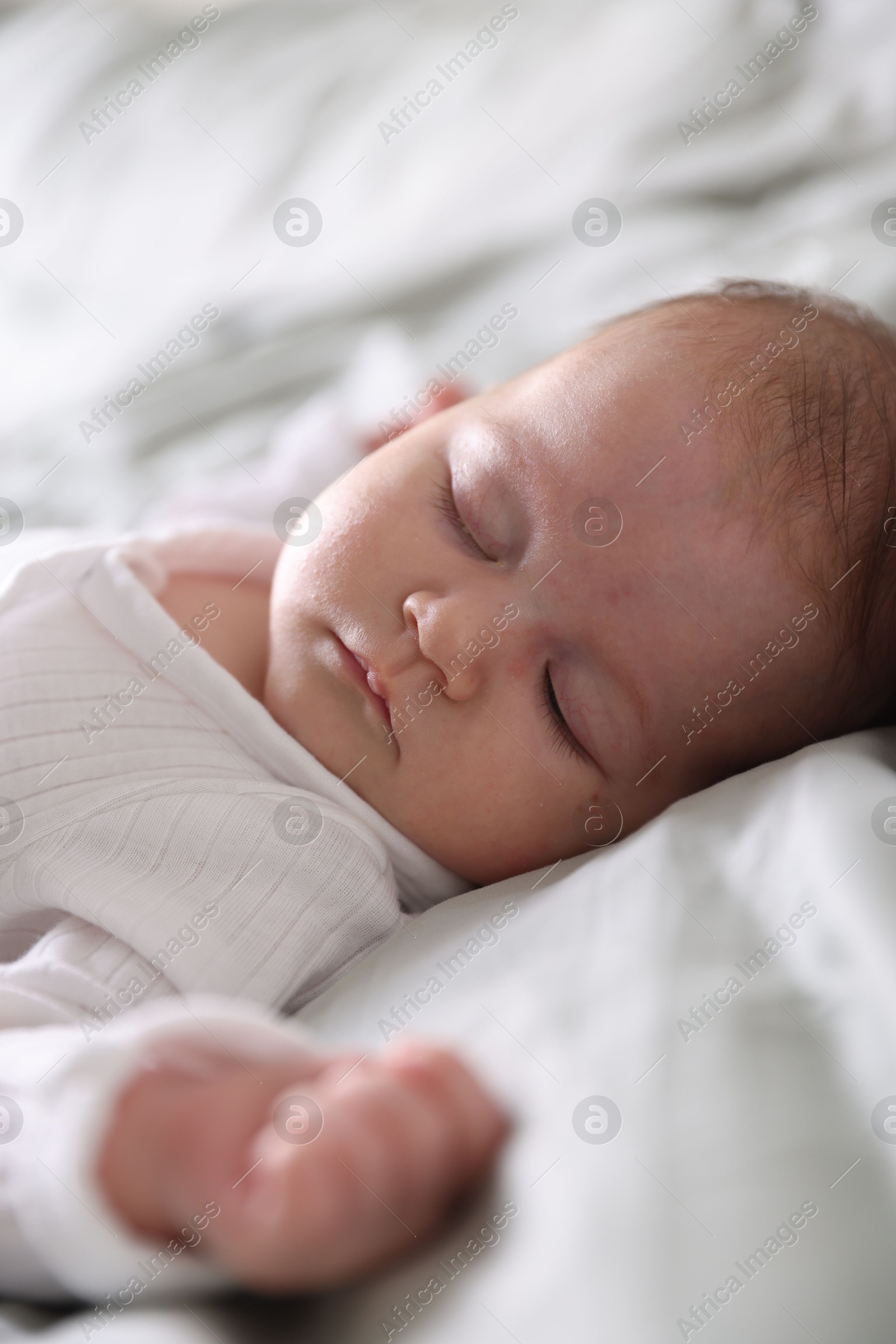 Cute newborn baby sleeping on bed, closeup Photo of Cute newborn baby sleeping on bed, closeup