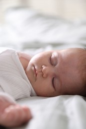 Photo of Cute newborn baby sleeping on bed, closeup