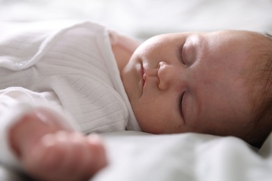 Photo of Cute newborn baby sleeping on bed, closeup