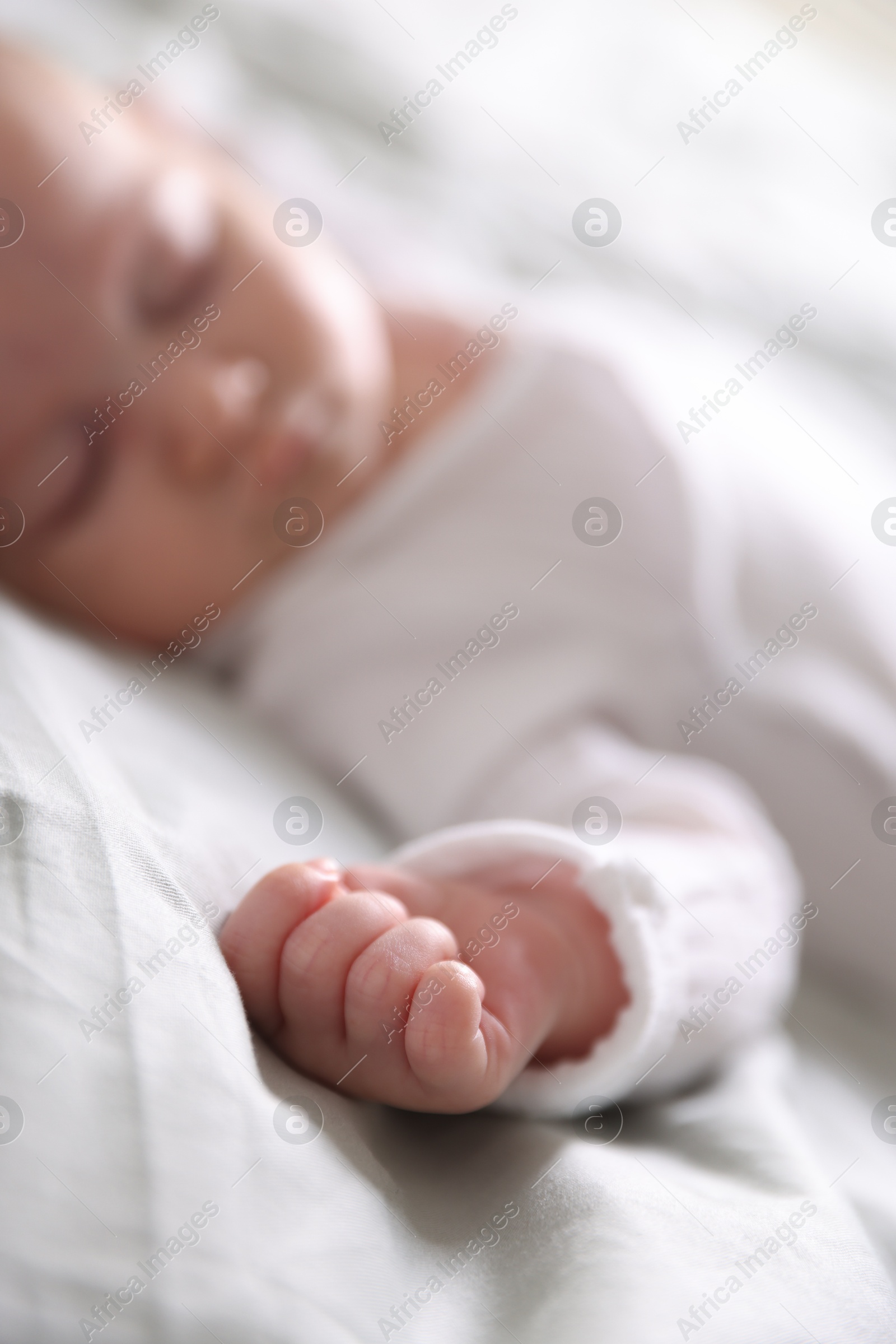 Cute newborn baby sleeping on bed, selective focus Photo of Cute newborn baby sleeping on bed, selective focus