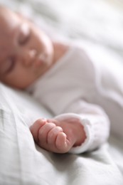 Photo of Cute newborn baby sleeping on bed, selective focus