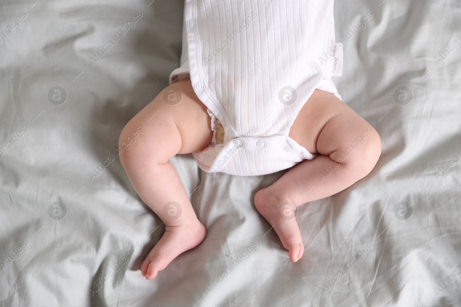 Cute newborn baby lying on bed, top view Photo of Cute newborn baby lying on bed, top view