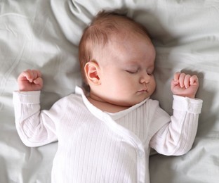 Photo of Cute newborn baby sleeping on bed, top view