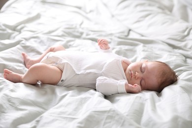 Photo of Cute sweet newborn baby sleeping on bed