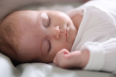 Photo of Cute newborn baby sleeping on bed, closeup