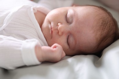 Photo of Cute newborn baby sleeping on bed, closeup