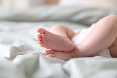 Photo of Cute newborn baby lying on bed, closeup