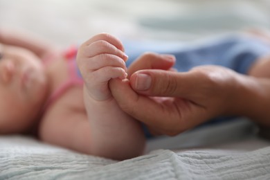 Photo of Mom with her newborn baby on bed, closeup