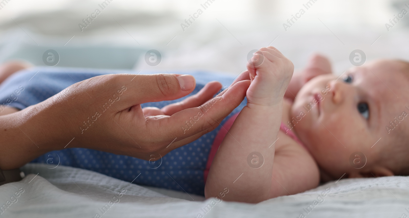 Mom with her newborn baby on bed, closeup Photo of Mom with her newborn baby on bed, closeup