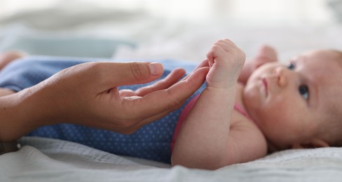 Photo of Mom with her newborn baby on bed, closeup