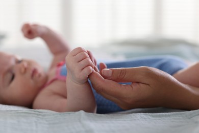 Photo of Mom with her newborn baby on bed, closeup