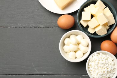 Photo of Different dairy products and eggs on grey wooden table, flat lay. Space for text