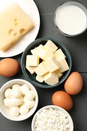 Photo of Different dairy products and eggs on grey wooden table, flat lay