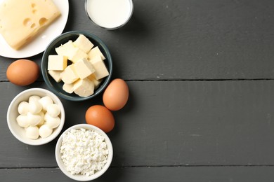 Photo of Different dairy products and eggs on grey wooden table, flat lay. Space for text