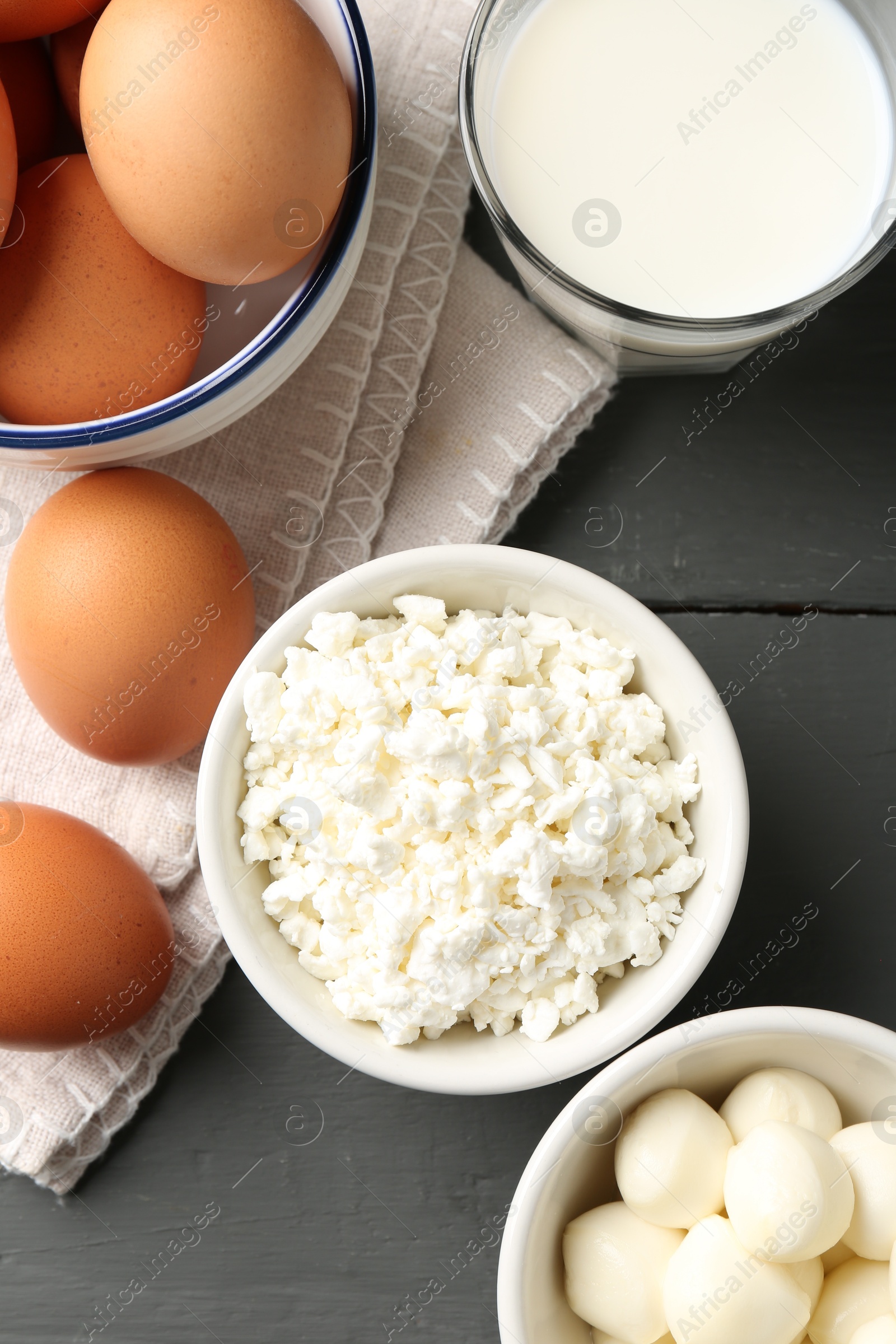 Different dairy products and eggs on grey wooden table, closeup Photo of Different dairy products and eggs on grey wooden table, closeup