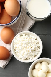 Photo of Different dairy products and eggs on grey wooden table, closeup
