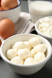 Photo of Different dairy products and eggs on grey wooden table, closeup
