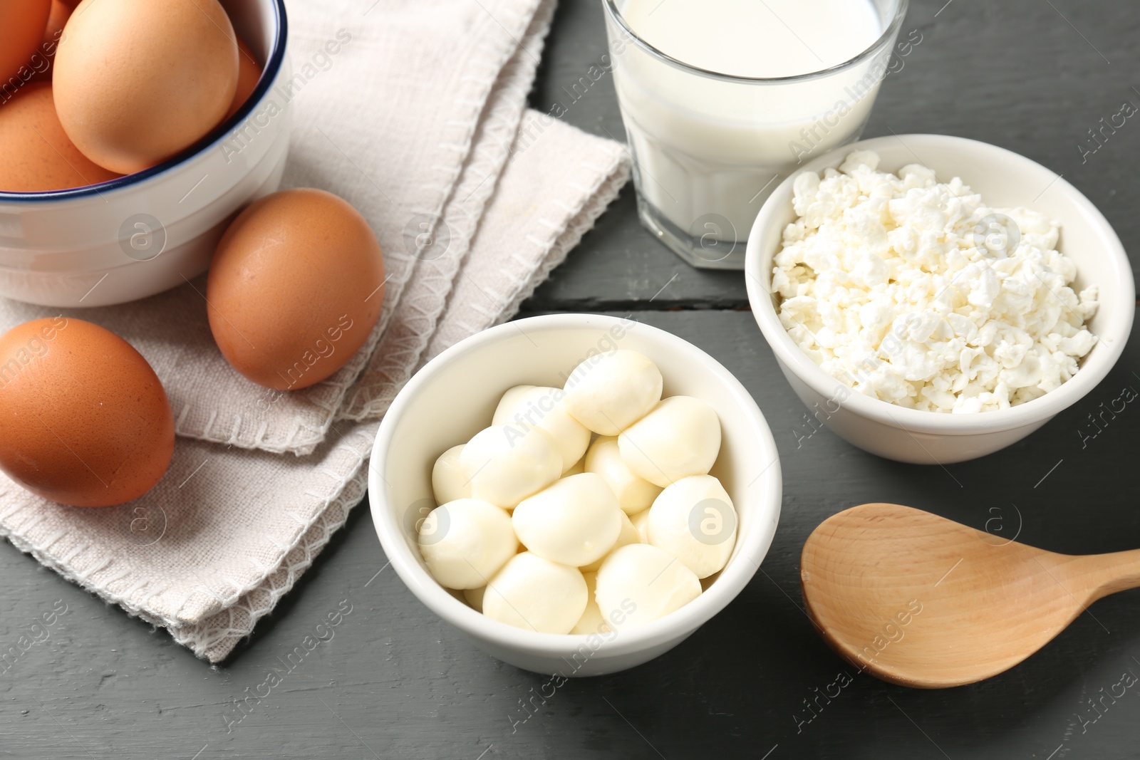 Different dairy products and eggs on grey wooden table, closeup Photo of Different dairy products and eggs on grey wooden table, closeup