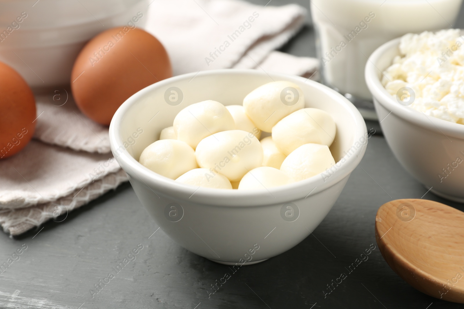 Different dairy products and eggs on grey wooden table, closeup Photo of Different dairy products and eggs on grey wooden table, closeup