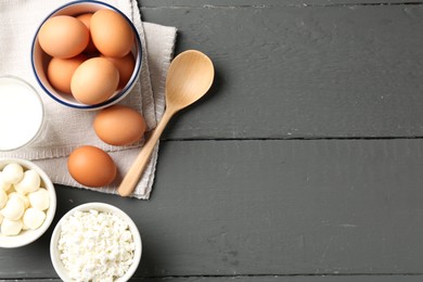 Photo of Different dairy products and eggs on grey wooden table, flat lay. Space for text