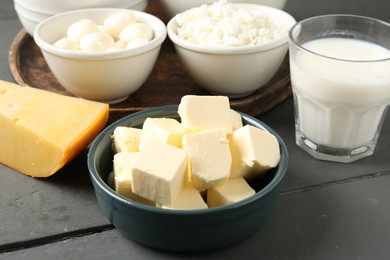 Photo of Different dairy products on grey wooden table, closeup