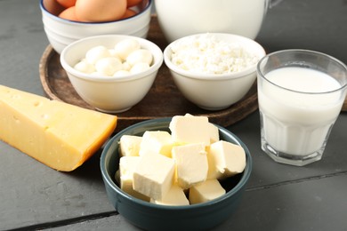 Photo of Different dairy products on grey wooden table, closeup