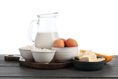 Photo of Different dairy products and eggs on grey wooden table against white background