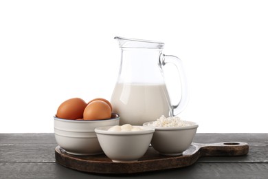 Photo of Different dairy products and eggs on grey wooden table against white background