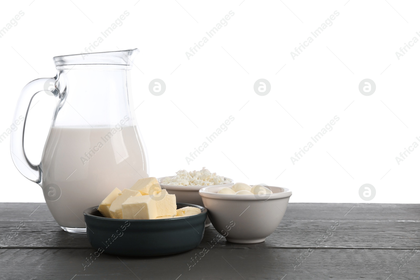Different dairy products on grey wooden table against white background Photo of Different dairy products on grey wooden table against white background