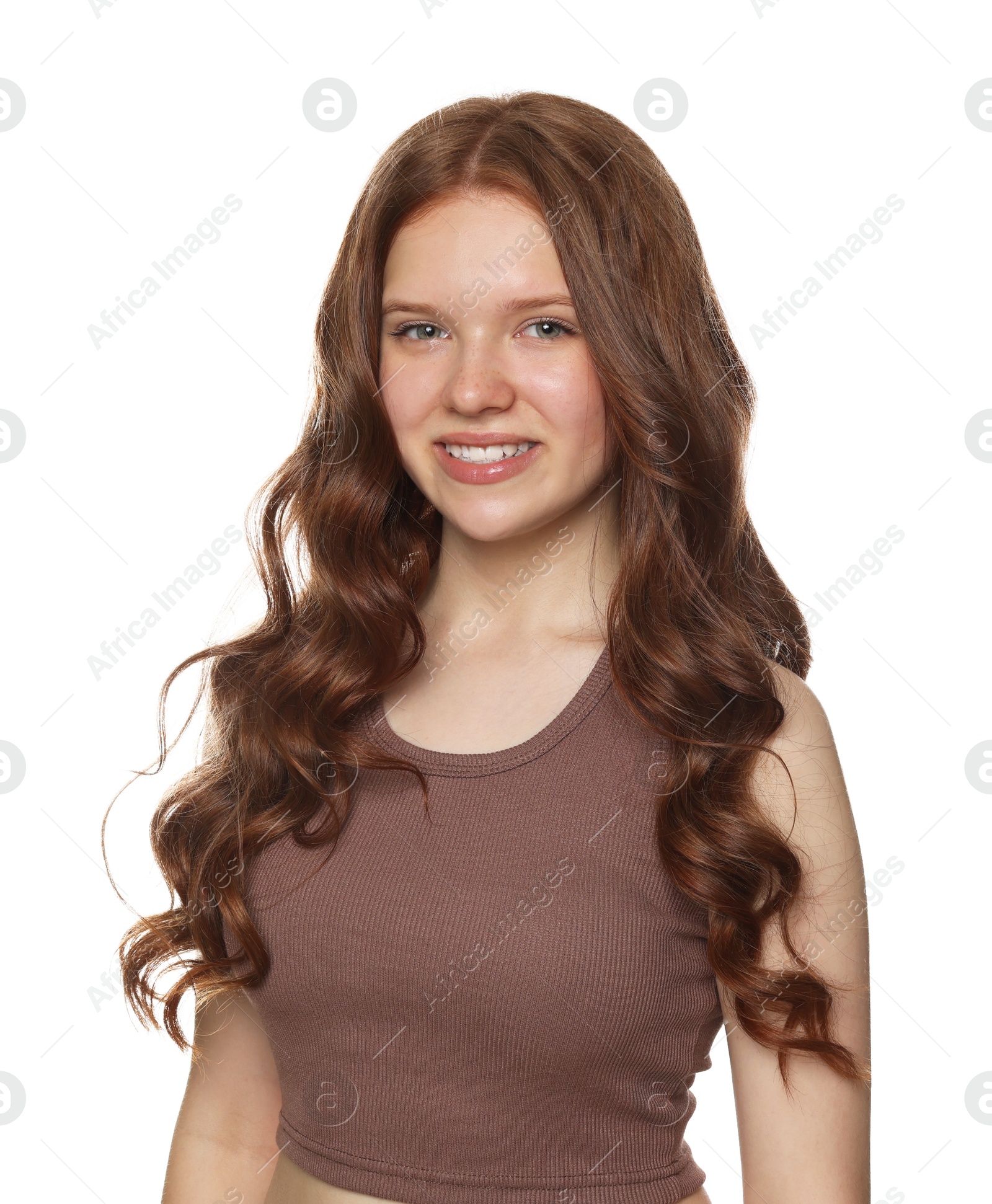 Portrait of smiling teenage girl with healthy wavy hair on white background Photo of Portrait of smiling teenage girl with healthy wavy hair on white background