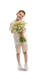 Photo of Smiling little boy with bouquet of beautiful chamomile flowers on white background