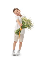 Photo of Smiling little boy with bouquet of beautiful chamomile flowers on white background