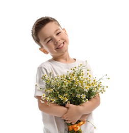 Photo of Smiling little boy with bouquet of beautiful chamomile flowers on white background