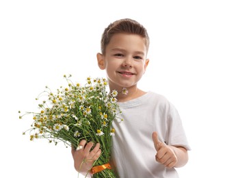 Photo of Smiling little boy with bouquet of beautiful chamomile flowers showing thumbs up on white background