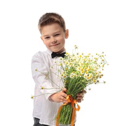Photo of Cute little boy giving bouquet of beautiful chamomile flowers on white background