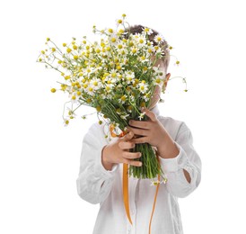 Photo of Little boy hiding behind bouquet of beautiful chamomile flowers on white background