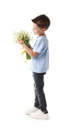 Photo of Little boy with bouquet of beautiful chamomile flowers on white background